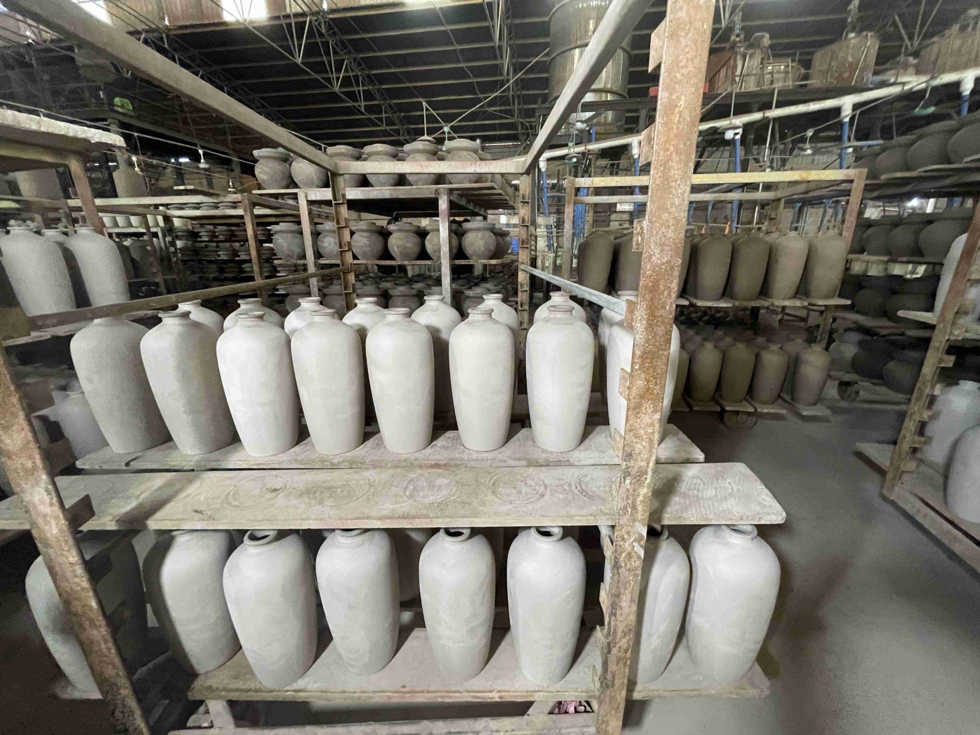 Dried terracotta bottles ready for glazing