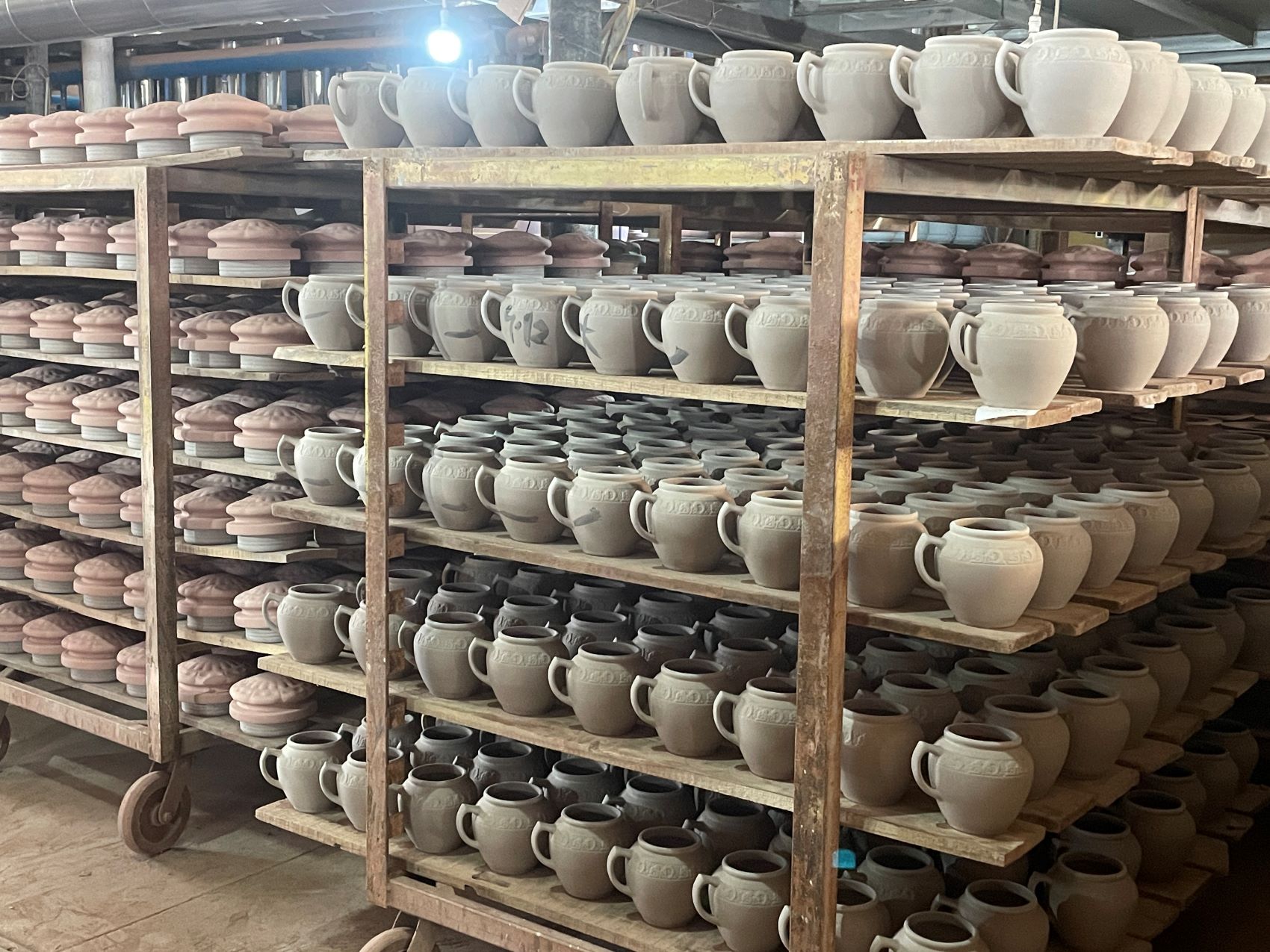 Small naturally dried terracotta storage jars on shelves