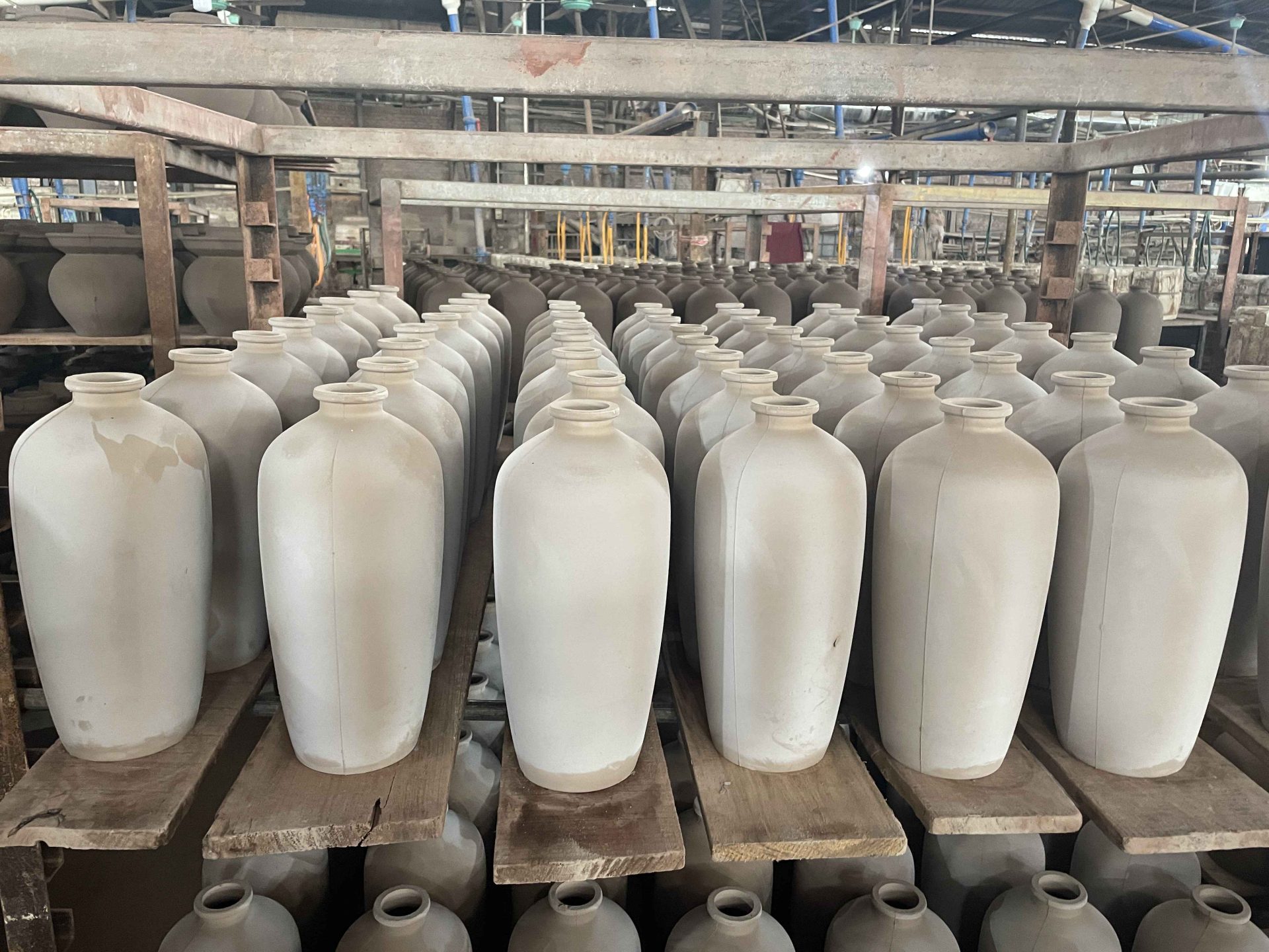 Terracotta bottles that undergo natural air drying on the shelves