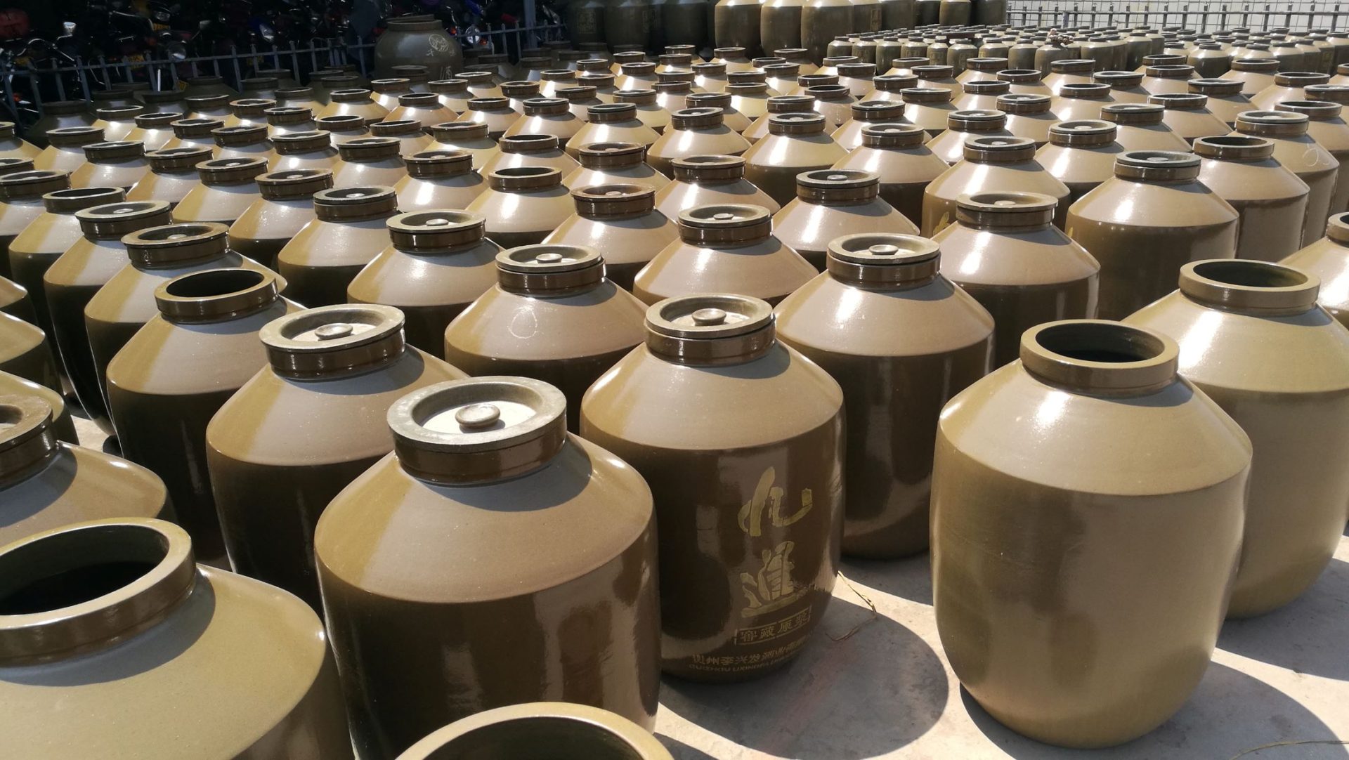 celadon glazed large wine jars waiting to be shipped in the warehouse
