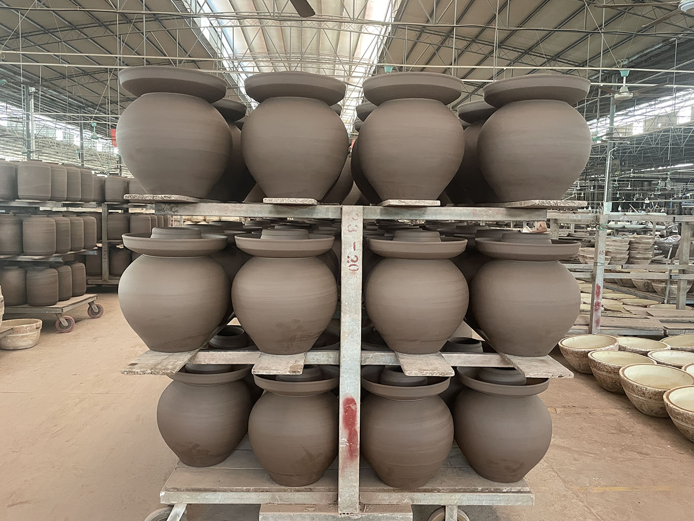 naturally dried clay kimchi crocks in a drying room