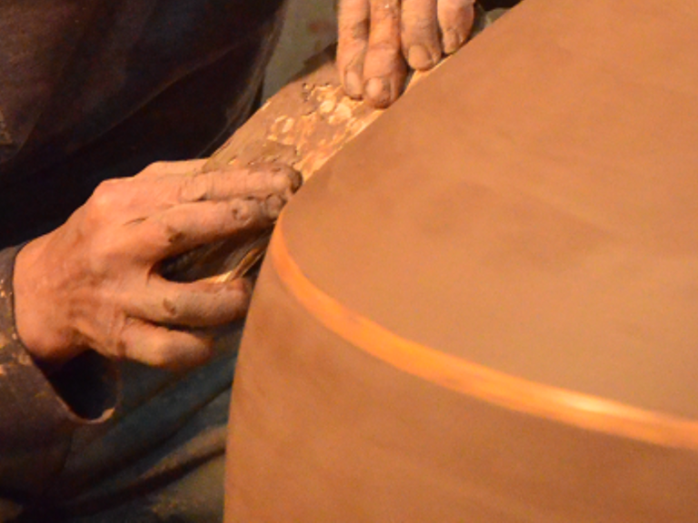 Craftsmen meticulously craft wine jar